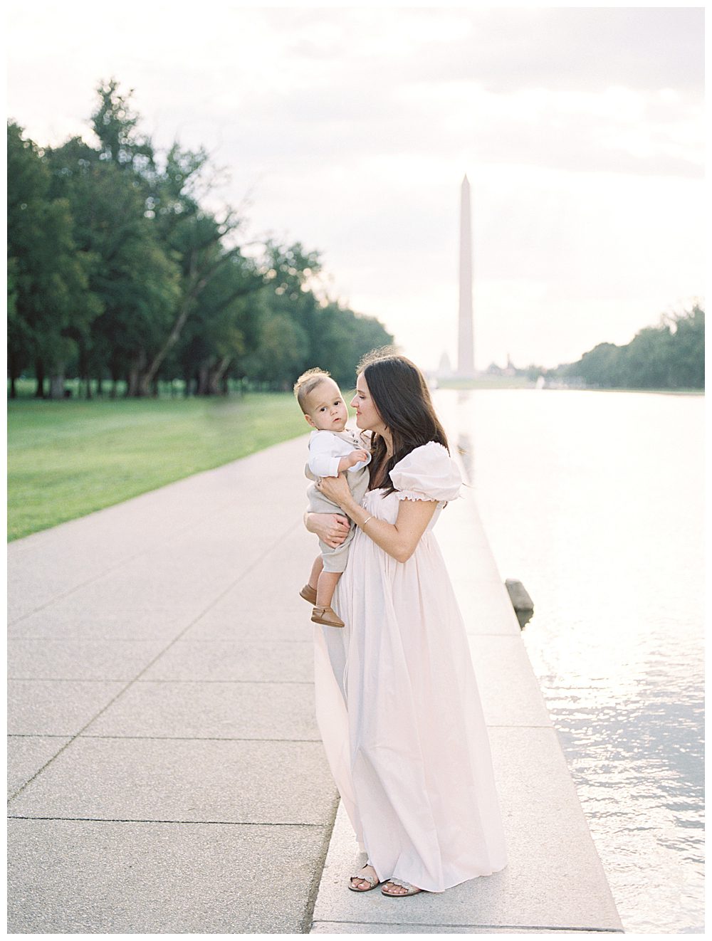Mother leans into son while standing at reflecting pool during DC Monuments Family Photo Session.