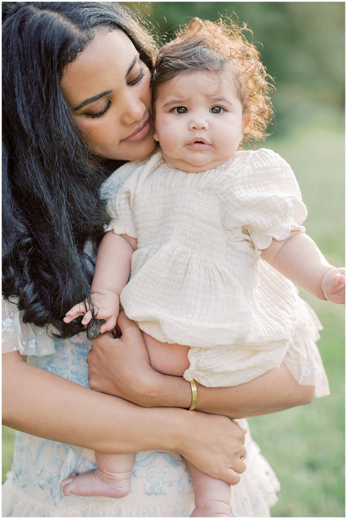Mother leans into her baby girl during Montgomery County Family Session at Brookside Gardens.