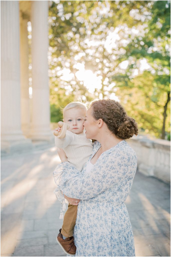 Mother snuggles into her toddler son during DAR Constitution Hall photos for family session.