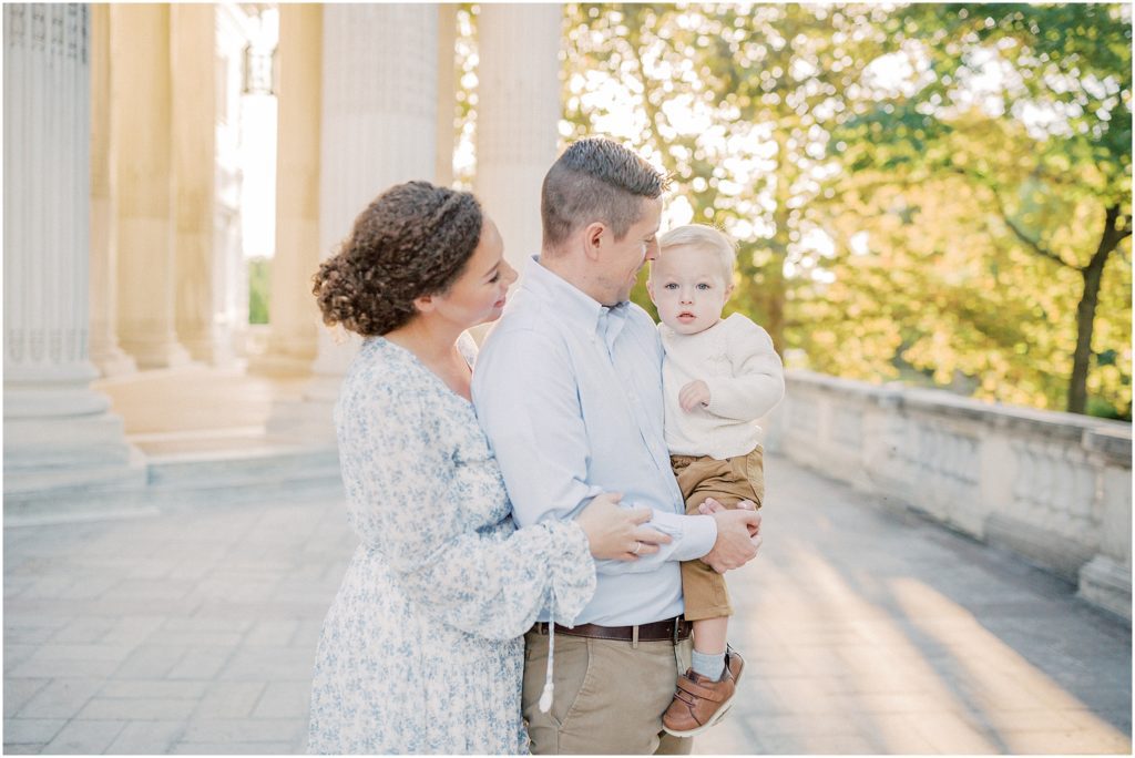 Mother and father hold their little boy during DAR Constitution Hall photos for family session.