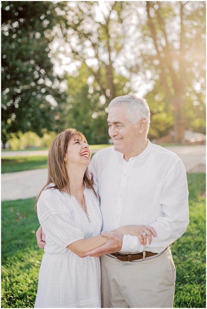 Couple in their 60's laugh at one another during outdoor photo session at Oatlands.