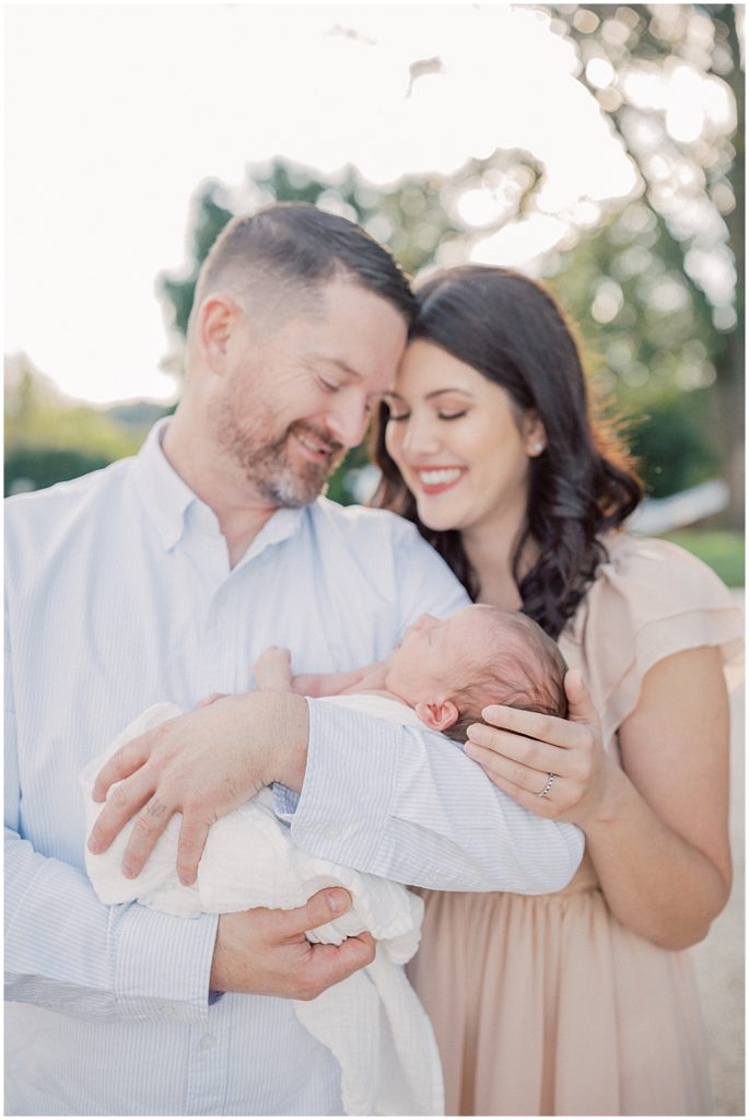 Father and mother hold their newborn baby boy during newborn session by Loudoun County Newborn Photographer Marie Elizabeth Photography.