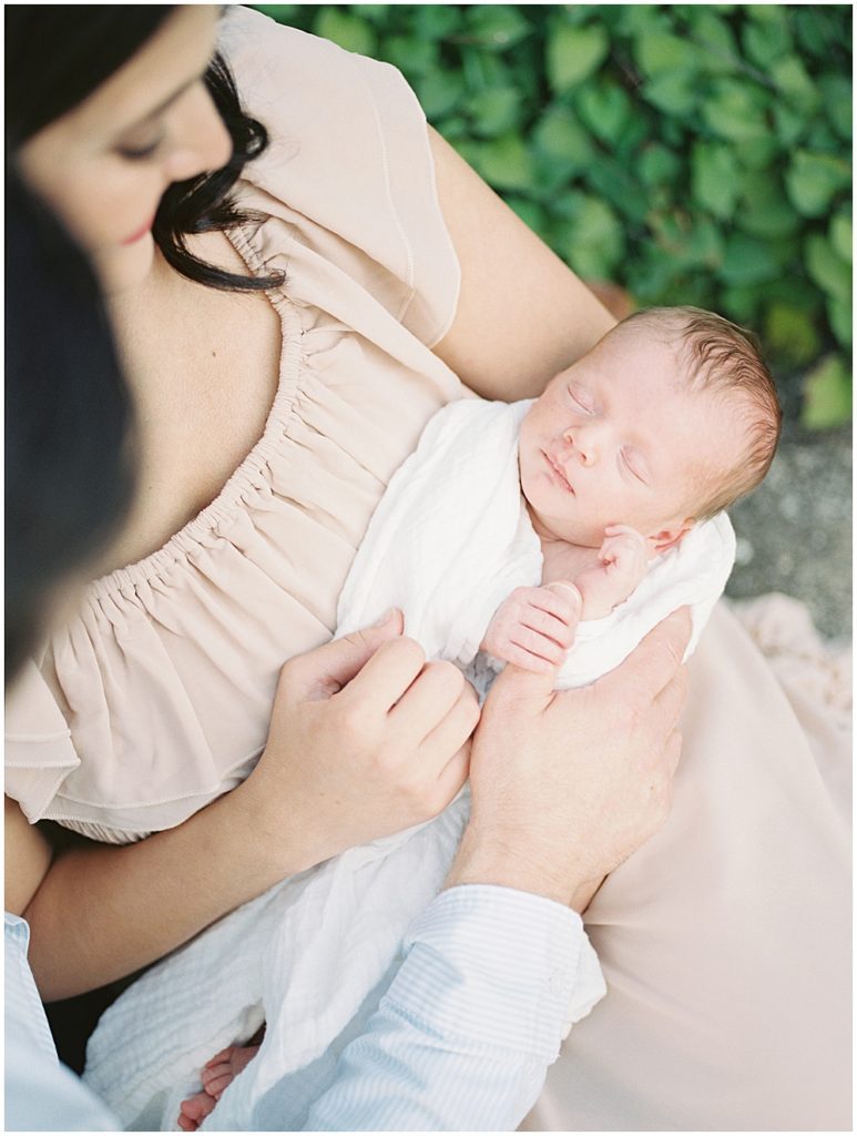 Baby boy held in his mother's arms during newborn session by Loudoun County Newborn Photographer Marie Elizabeth Photography.