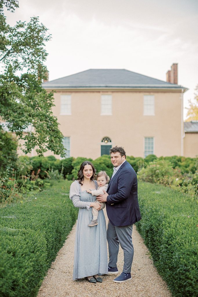 Parents stand in front of Tudor Place in DC with baby boy photographed by Georgetown Family Photographer Marie Elizabeth Photography.
