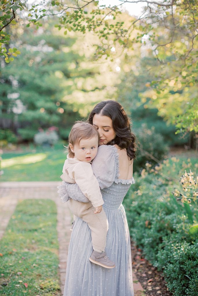 Mother leans into toddler during family session at Tudor Place by Georgetown Family Photographer Marie Elizabeth Photography
