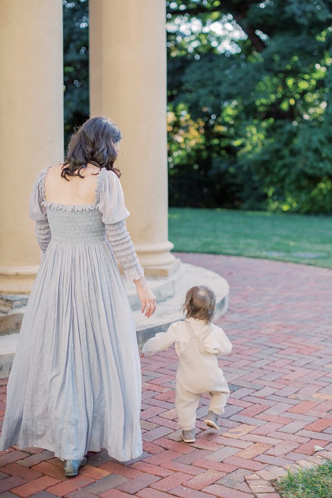 Mother walks with toddler son at Tudor Place photographed by Georgetown Family Photographer Marie Elizabeth Photography.