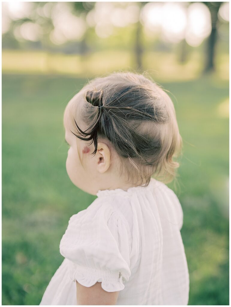 Close-up view of toddler girl with brown pig tails.