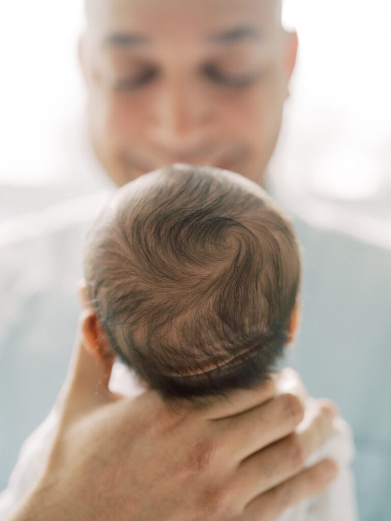 A close-up view of a newborn baby's hair swirl during their newborn photos in Arlington.